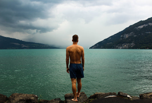 Hombre descalzo mirando el horizonte